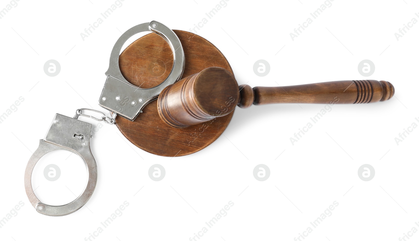 Photo of Handcuffs and judge's gavel isolated on white, top view