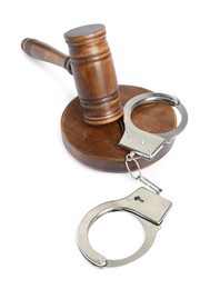 Photo of Handcuffs and judge's gavel isolated on white