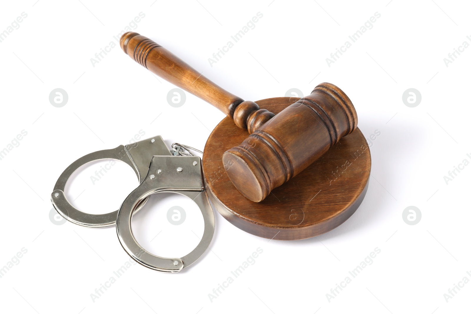 Photo of Handcuffs and judge's gavel isolated on white