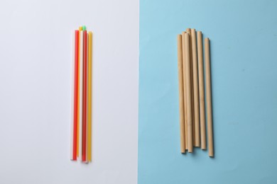 Photo of Plastic and bamboo drinking straws on color background, flat lay