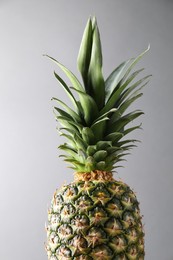 Fresh ripe pineapple on light grey background, closeup