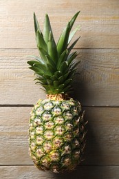 Fresh ripe pineapple on wooden table, top view