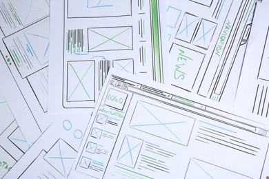 Developing UI design. Sketches of website wireframes as background, top view