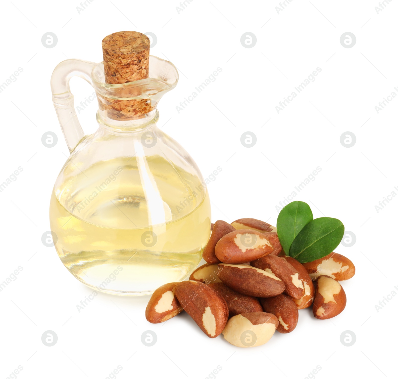 Photo of Tasty Brazil nuts and jug with oil isolated on white