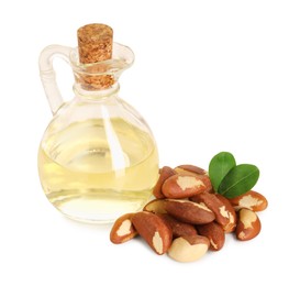 Photo of Tasty Brazil nuts and jug with oil isolated on white