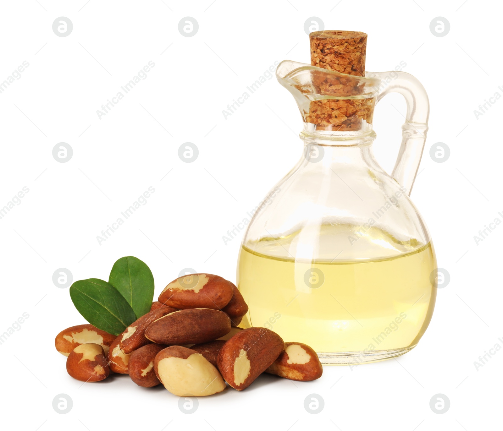 Photo of Tasty Brazil nuts and jug with oil isolated on white