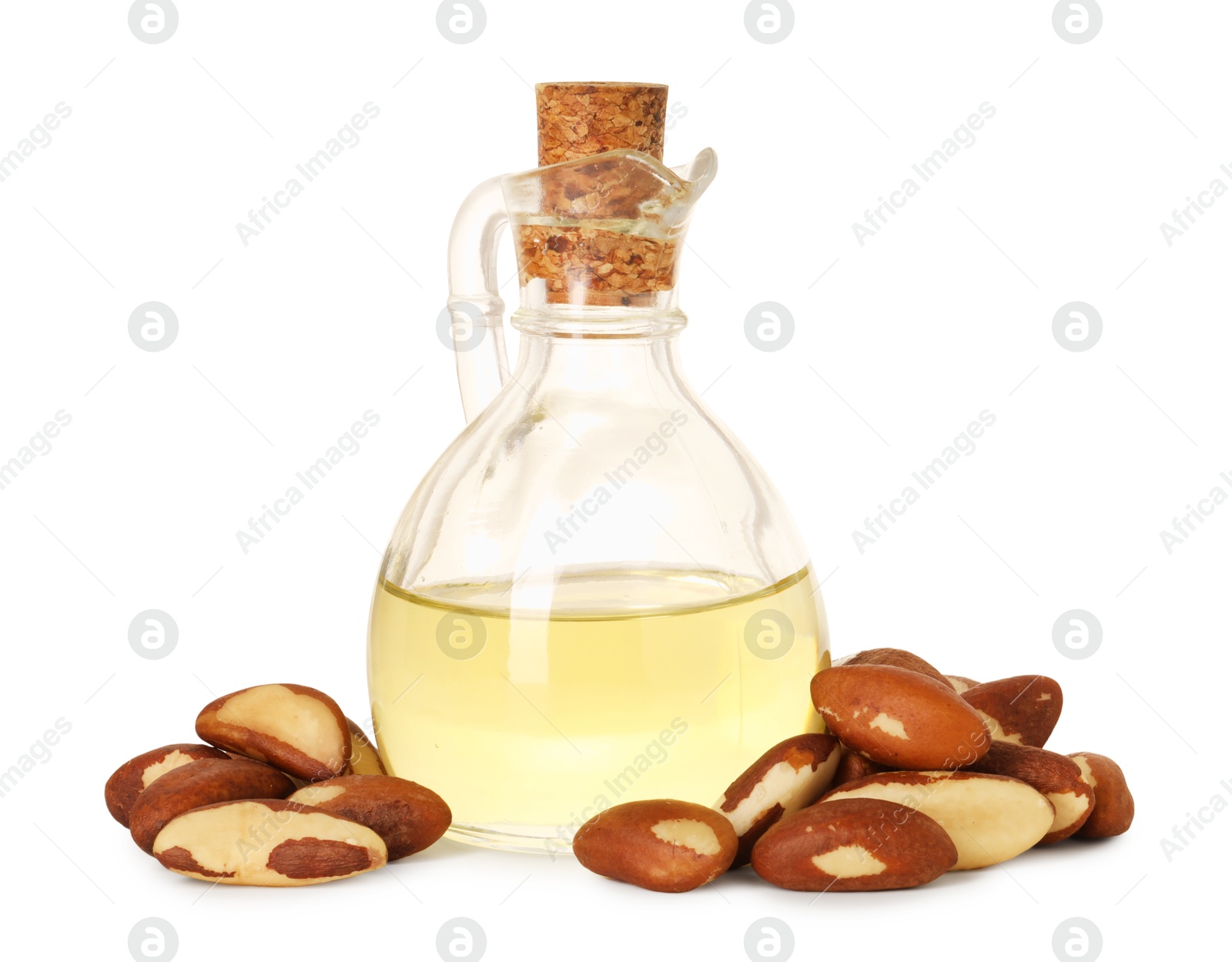 Photo of Tasty Brazil nuts and jug with oil isolated on white