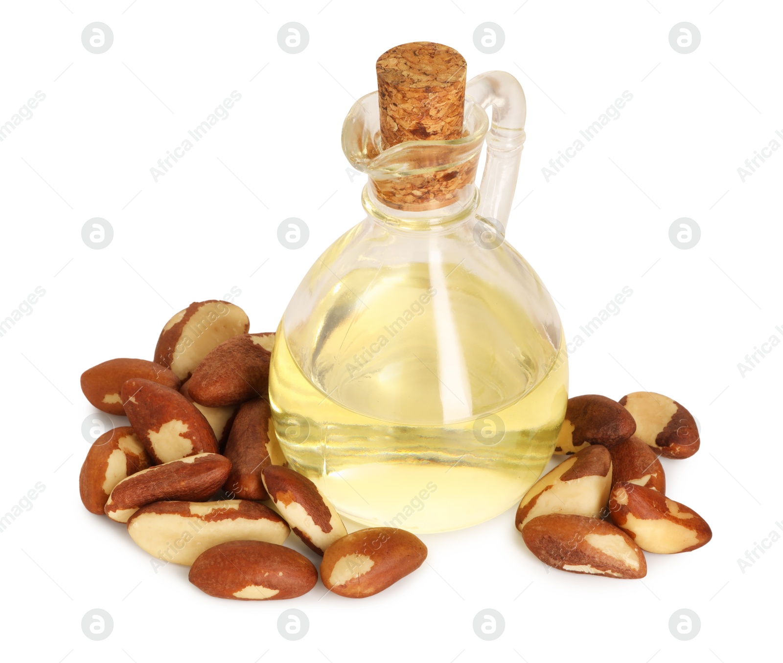 Photo of Tasty Brazil nuts and jug with oil isolated on white