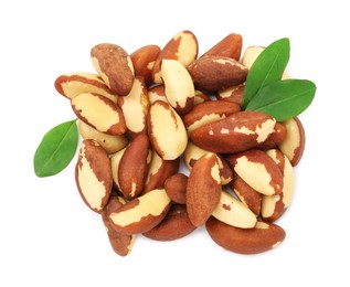 Photo of Tasty Brazil nuts and green leaves isolated on white, top view