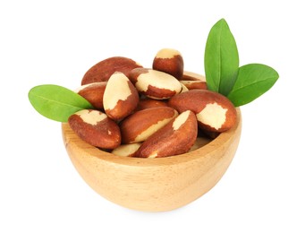 Photo of Tasty Brazil nuts and green leaves in bowl isolated on white