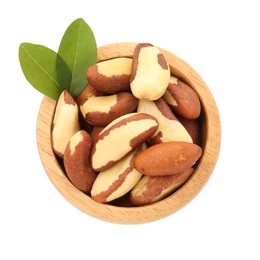 Photo of Tasty Brazil nuts and green leaves in bowl isolated on white, top view