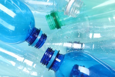 Photo of Many plastic bottles on light background, closeup