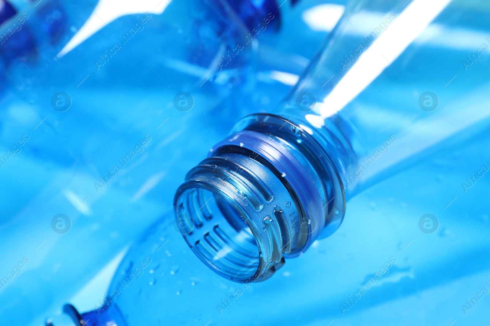 Photo of Many plastic bottles on light background, closeup