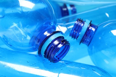 Photo of Many plastic bottles on light background, closeup