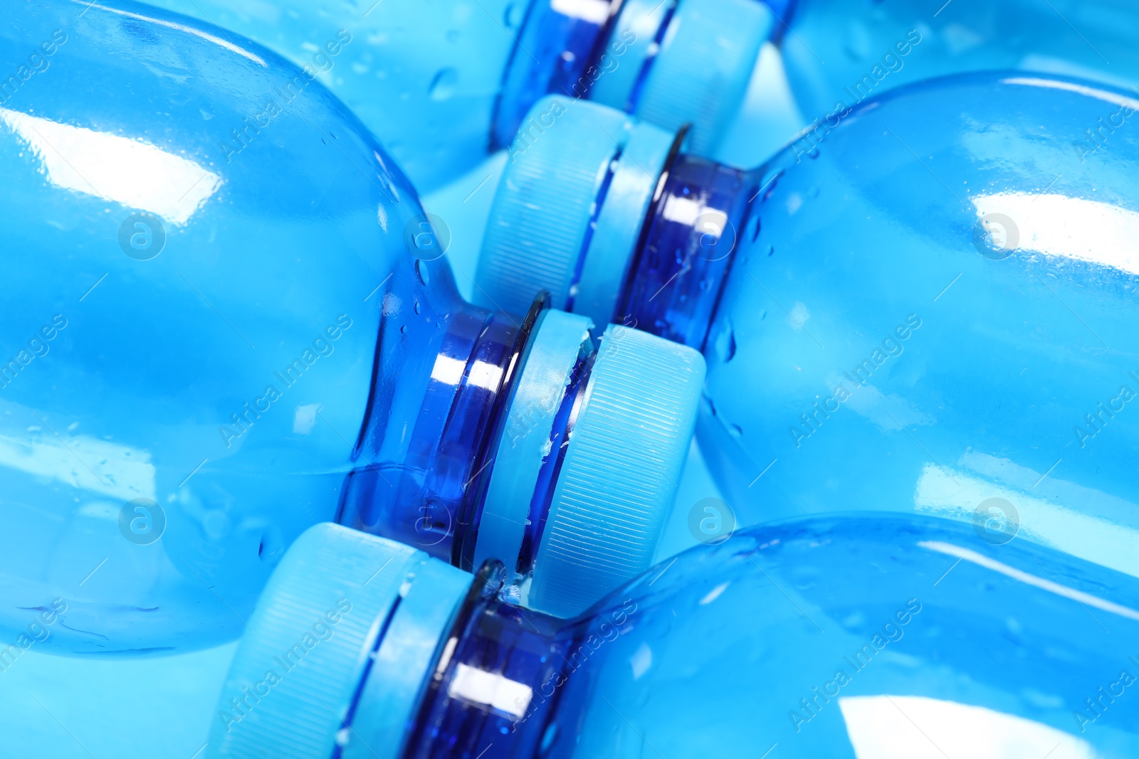 Photo of Many plastic bottles on light background, closeup