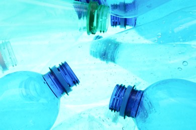 Photo of Many plastic bottles as background, closeup view