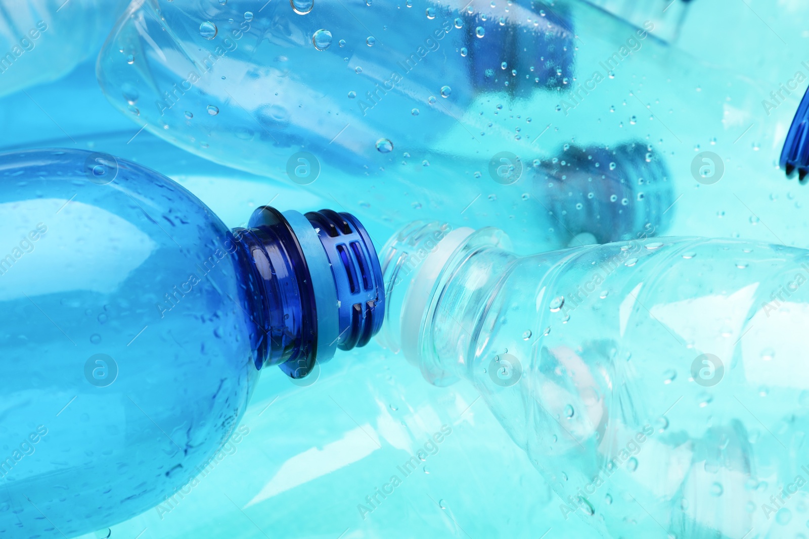 Photo of Many plastic bottles as background, closeup view