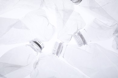 Crumpled plastic bottles on white background, closeup