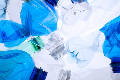 Photo of Crumpled plastic bottles on white background, closeup