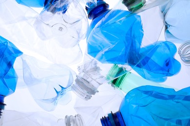 Photo of Crumpled plastic bottles on white background, closeup