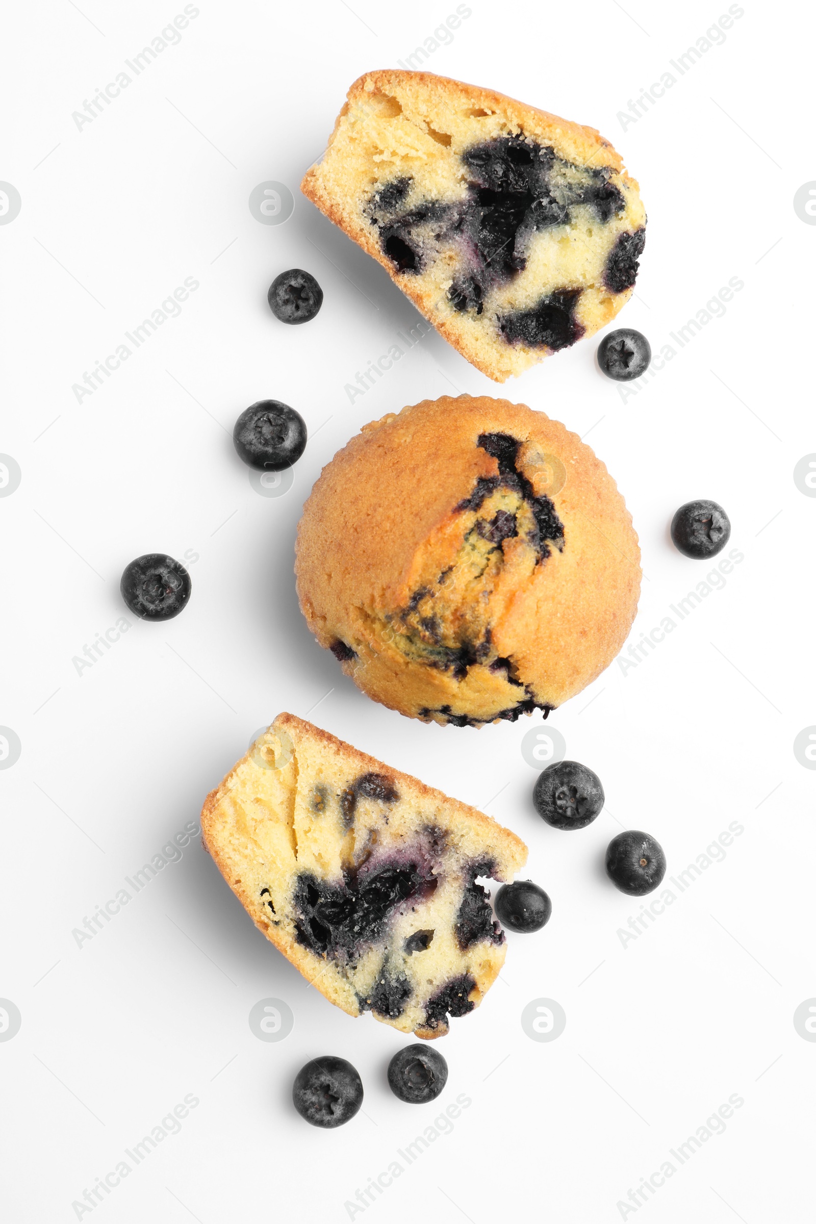 Photo of Delicious sweet muffins with blueberries isolated on white, top view