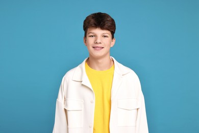 Photo of Portrait of teenage boy on light blue background