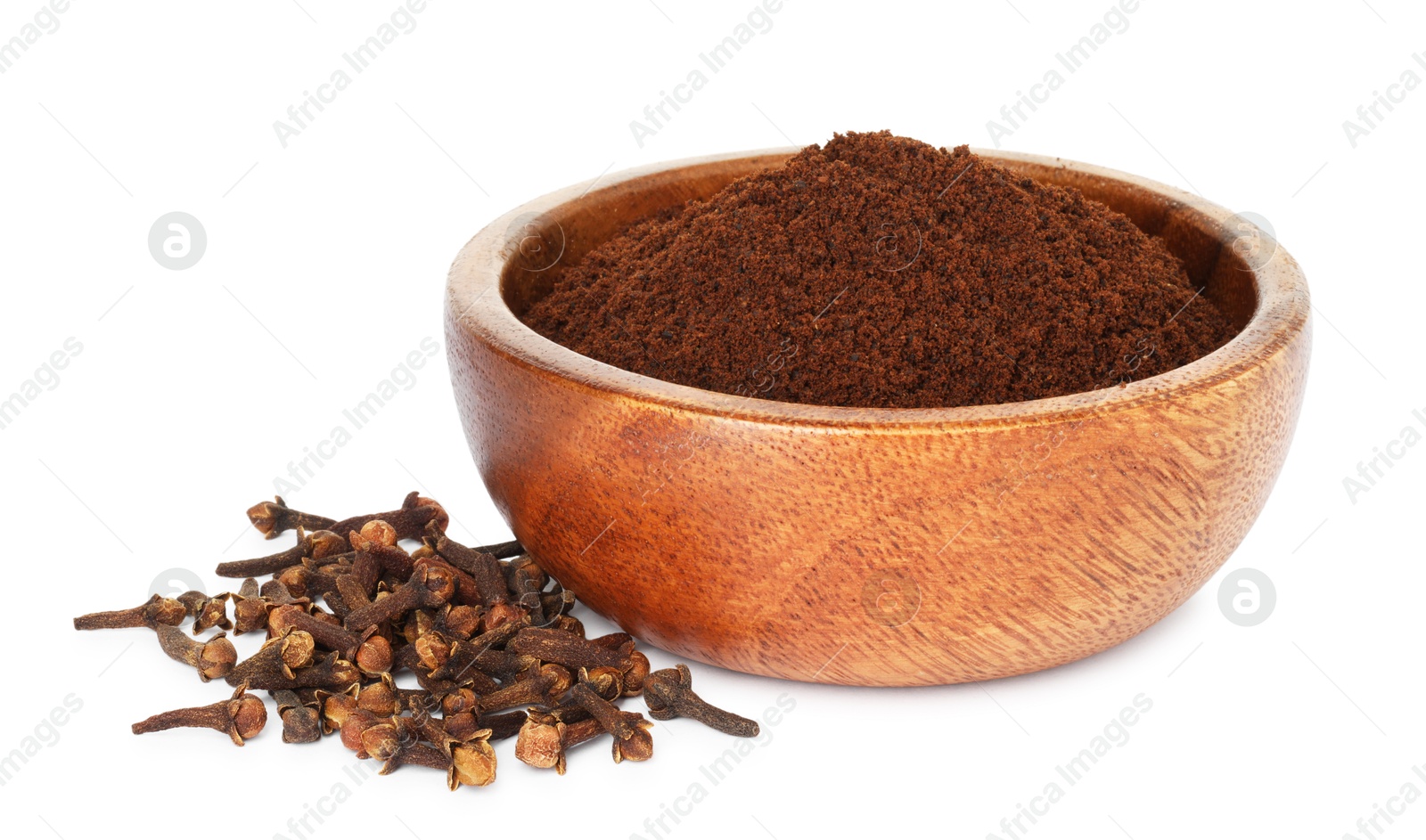 Photo of Clove powder in wooden bowl and dried buds on white background. Aromatic spice