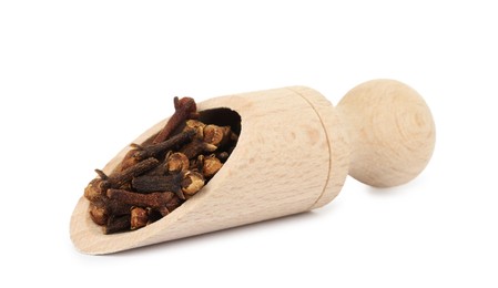 Photo of Dry clove buds in wooden scoop on white background. Aromatic spice