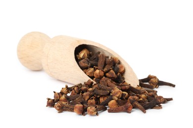 Photo of Dry clove buds in wooden scoop on white background. Aromatic spice