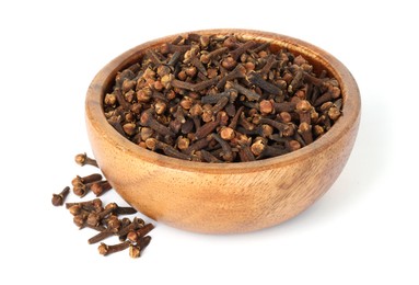 Photo of Dry clove buds in wooden bowl on white background. Aromatic spice