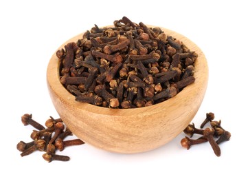 Photo of Dry clove buds in wooden bowl on white background. Aromatic spice