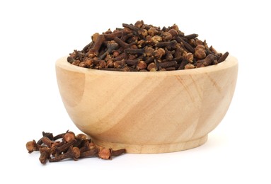 Photo of Dry clove buds in wooden bowl on white background. Aromatic spice