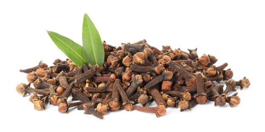 Pile of dry clove buds and green leaves on white background. Aromatic spice