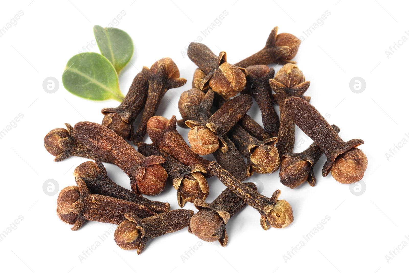 Photo of Pile of dry clove buds and green leaves on white background. Aromatic spice