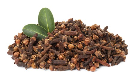 Photo of Pile of dry clove buds and green leaves on white background. Aromatic spice