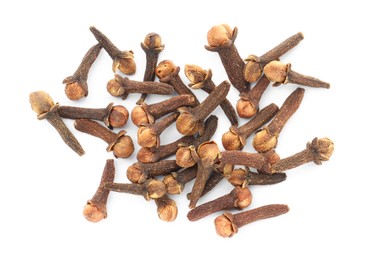 Photo of Pile of dry clove buds on white background, top view. Aromatic spice