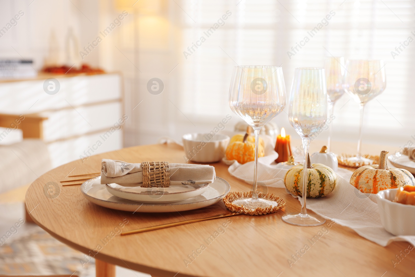 Photo of Stylish table setting with beautiful dishware and autumn decor in dining room