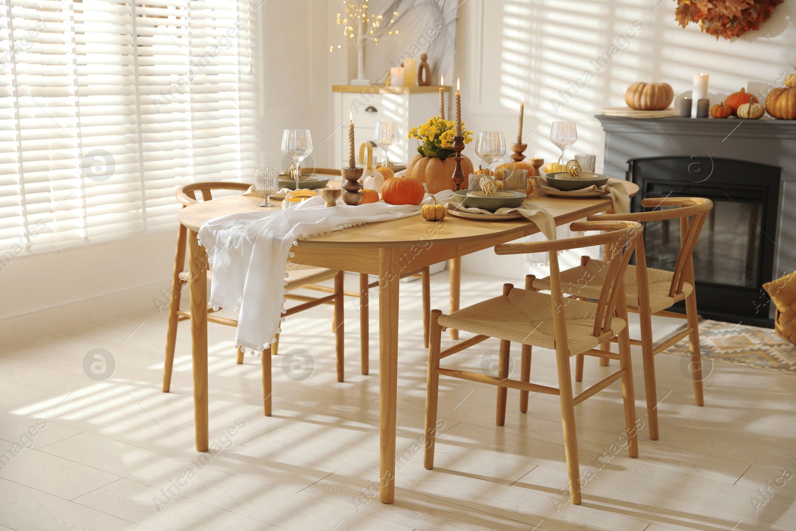 Photo of Stylish dining room with beautiful table setting and autumn decor