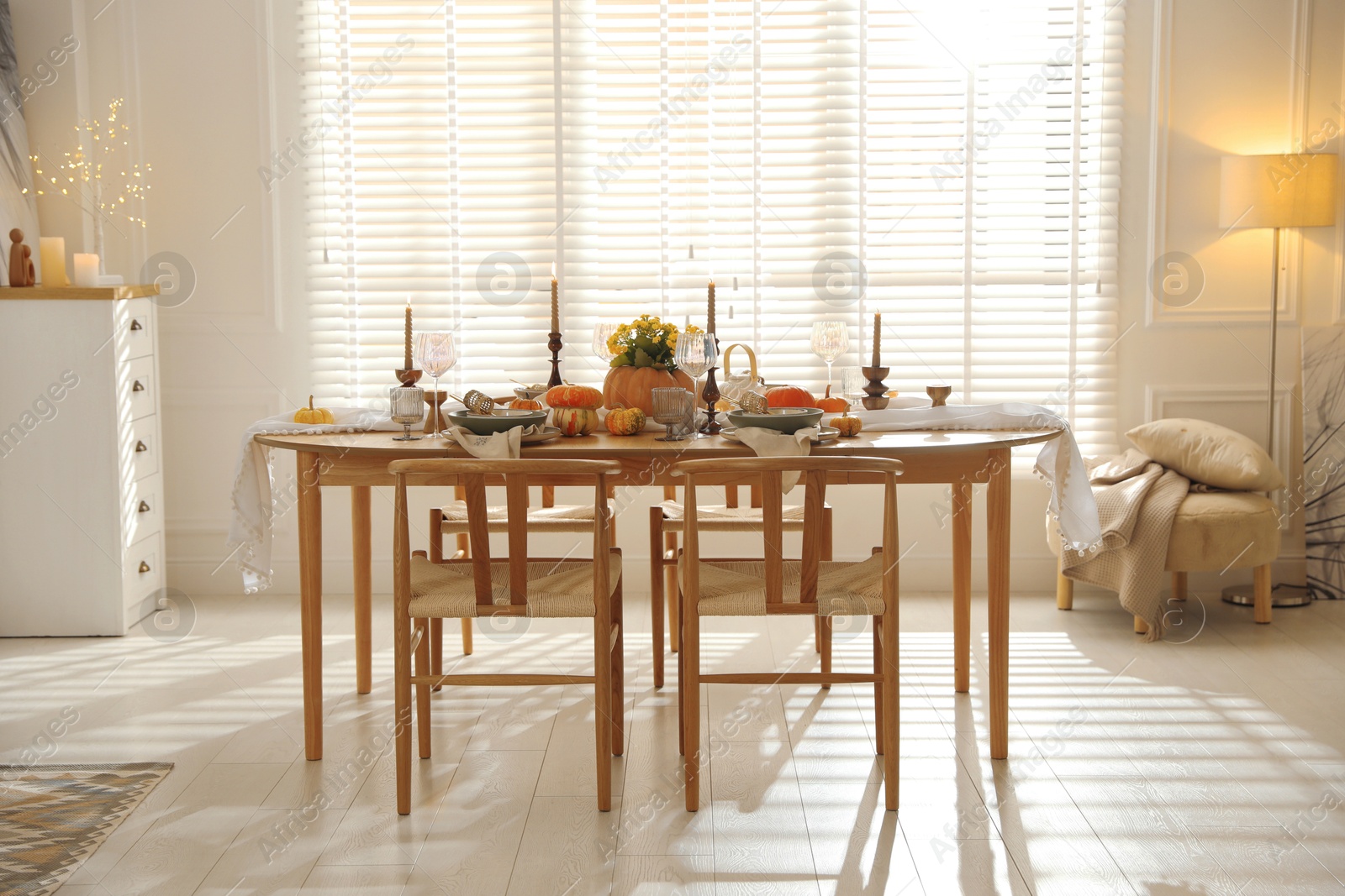 Photo of Stylish dining room with beautiful table setting and autumn decor