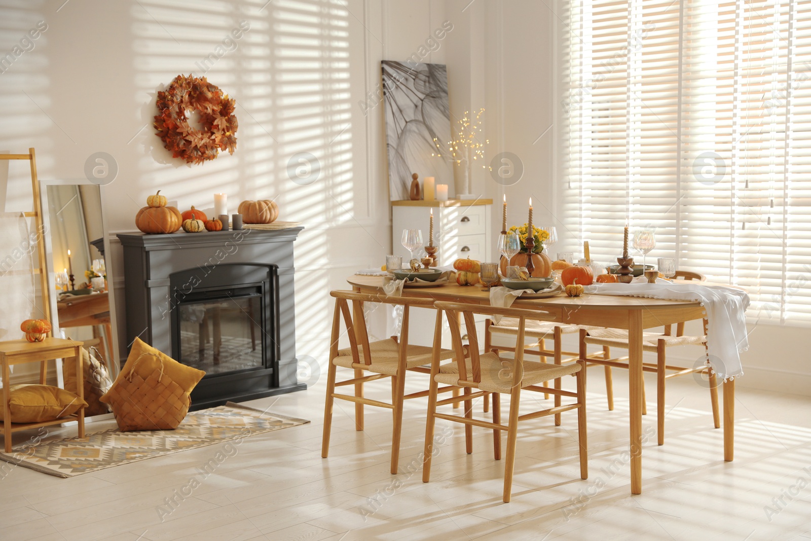 Photo of Stylish dining room with beautiful table setting and autumn decor