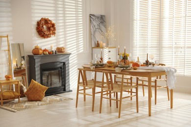 Stylish dining room with beautiful table setting and autumn decor