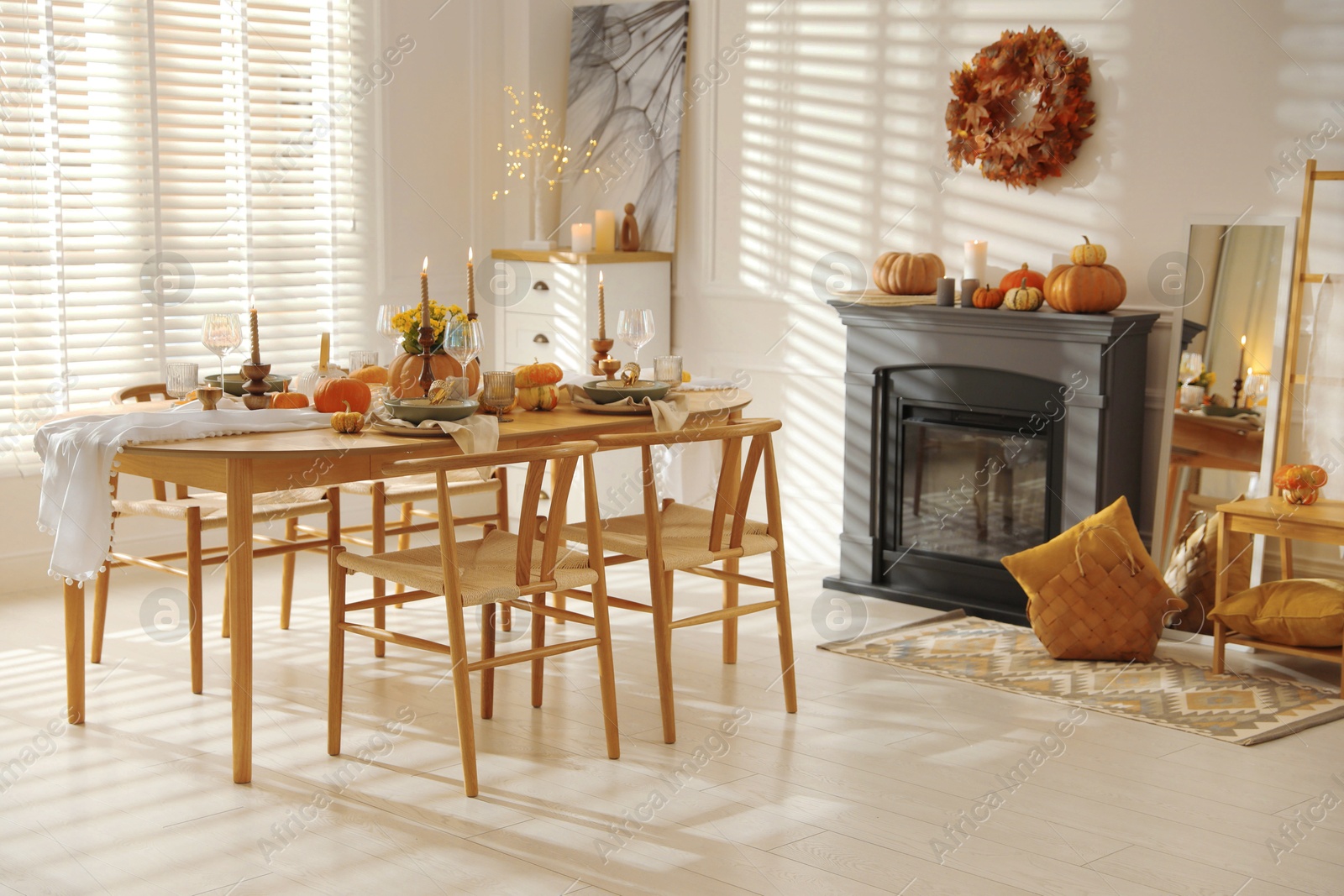 Photo of Stylish dining room with beautiful table setting and autumn decor