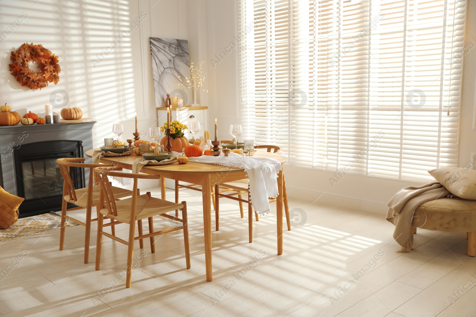 Photo of Stylish dining room with beautiful table setting and autumn decor