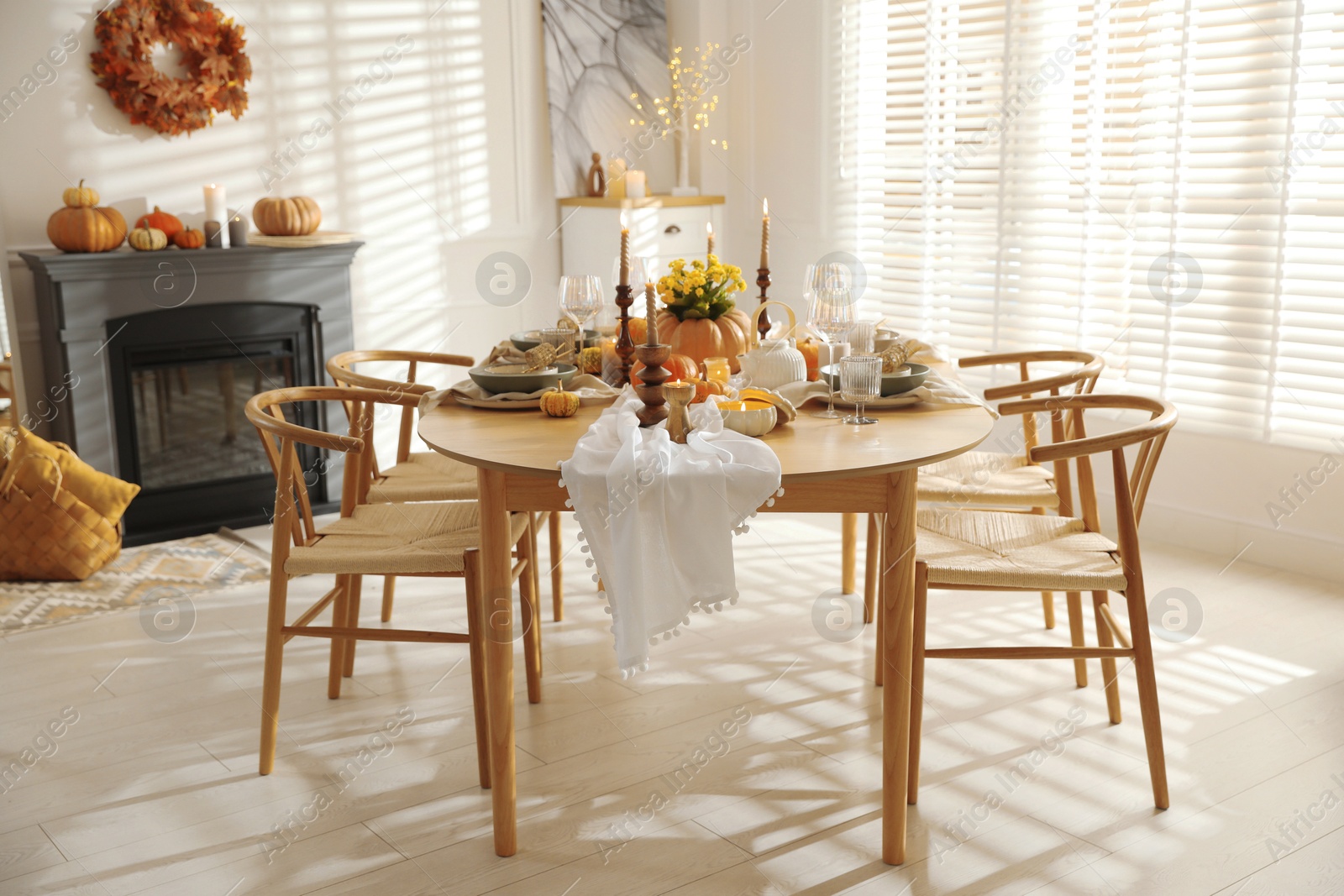 Photo of Stylish dining room with beautiful table setting and autumn decor