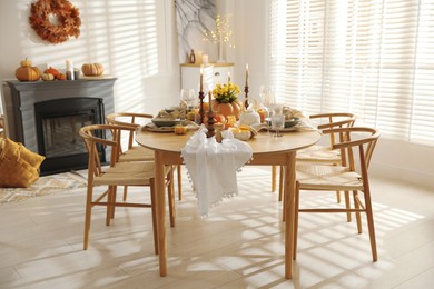 Stylish dining room with beautiful table setting and autumn decor