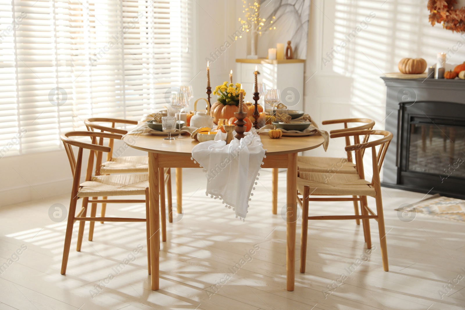 Photo of Stylish dining room with beautiful table setting and autumn decor