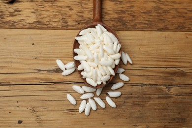 Photo of Puffed rice in spoon on wooden table, top view