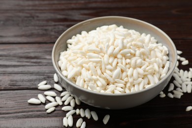 Photo of Puffed rice in bowl on wooden table, closeup