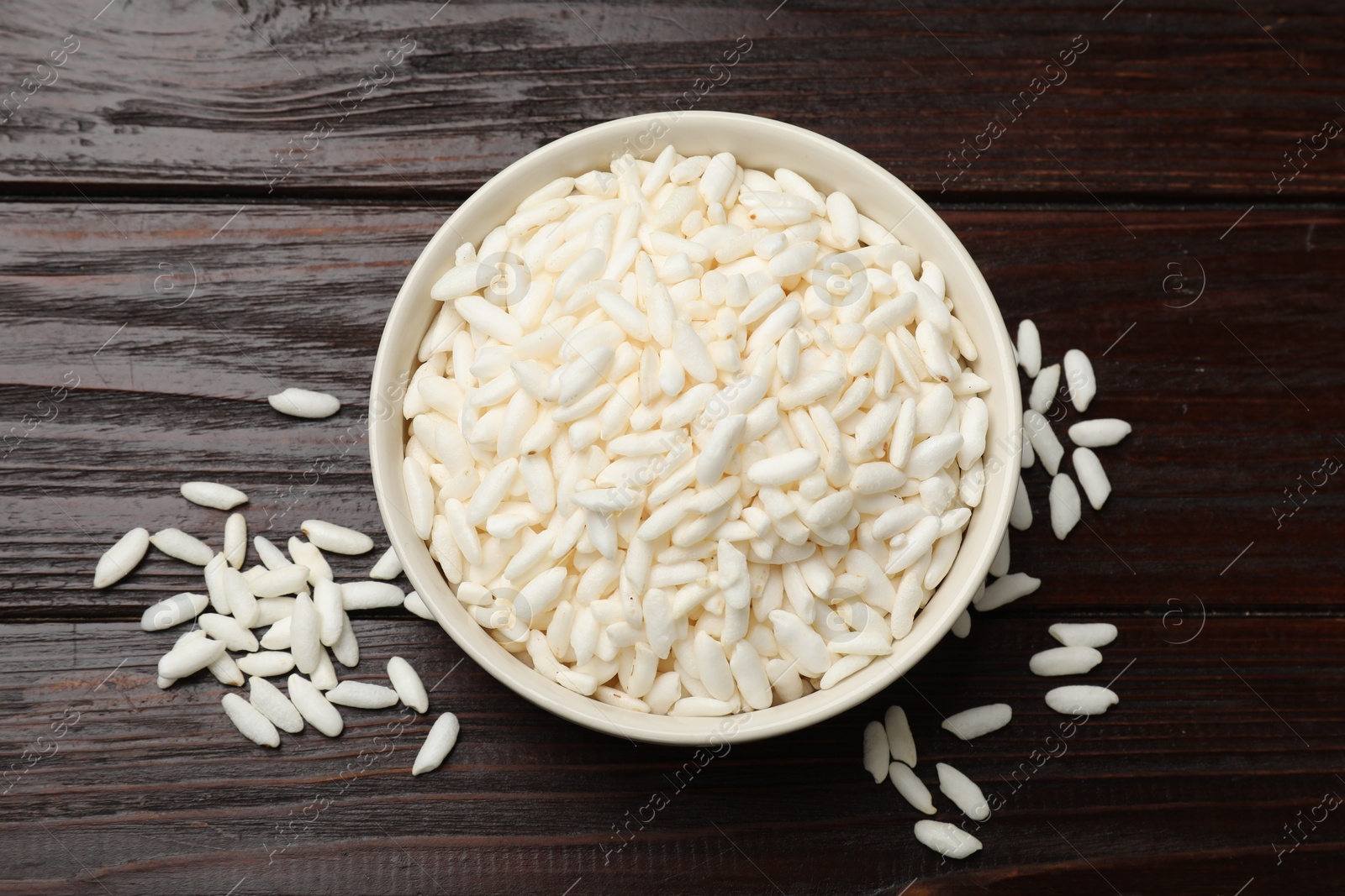 Photo of Puffed rice in bowl on wooden table, top view