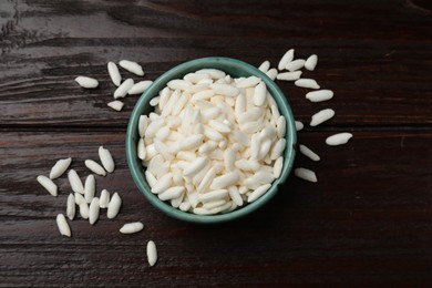 Photo of Puffed rice in bowl on wooden table, top view